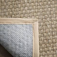 a close up view of the corner of a rug with a blue and white polka dot design on it