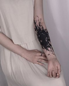 a woman with black ink on her arm