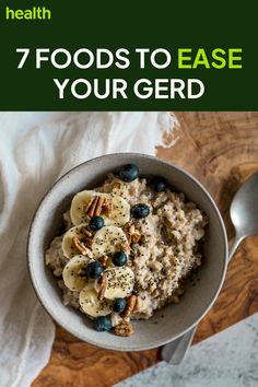 a bowl filled with oatmeal and blueberries on top of a wooden table