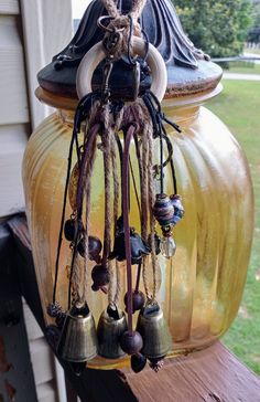 a vase with bells hanging from it's side