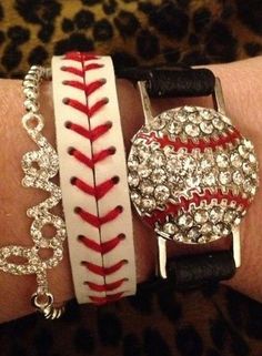 a close up of a person's arm wearing bracelets with baseball charms on them