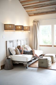 a person laying on top of a bed in a room