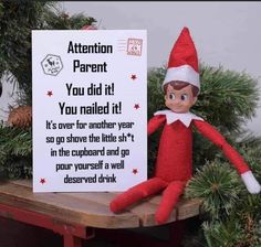 an elf is sitting next to a sign that says attention parent you did it you nailed it