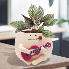 a potted plant with a guitar on it