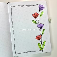 an open notebook with flowers drawn on it