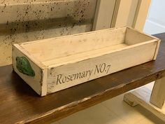 a wooden box with the words rosemary no 7 on it sitting on top of a table