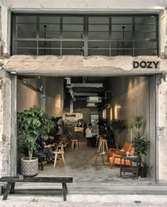 an open door to a restaurant with people sitting at tables and chairs in front of it