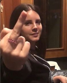 a woman making the peace sign with her fingers