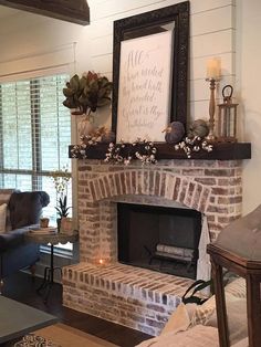 a living room filled with furniture and a fire place in front of a brick fireplace