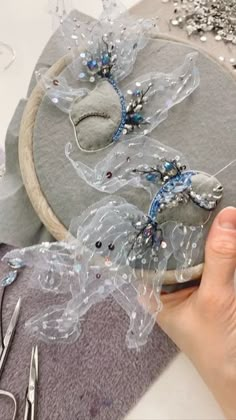 someone is working on something with beads and sequins