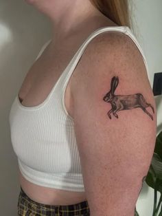 a woman with a rabbit tattoo on her arm