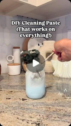 a person is spooning something out of a jar on a counter top with the words diy cleaning paste that works on everything