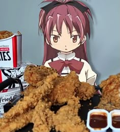 fried chicken and other foods on a table next to a paper cutout of an anime character