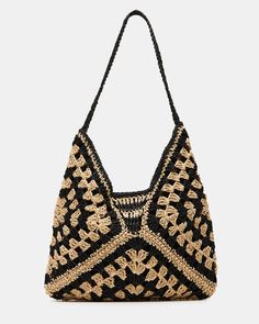 a black and gold handbag with an intricate design on the front, in crochet