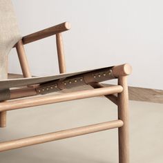 a wooden chair sitting on top of a white floor