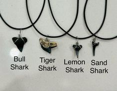 four necklaces with different types of animals on them, all in black and white