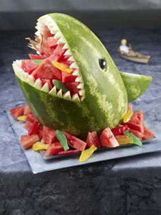 there is a watermelon shaped like a shark with its mouth open and teeth out