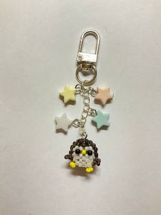 a keychain with a cartoon character on it and stars around the key chain