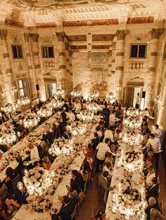 a large banquet hall filled with people sitting at long tables