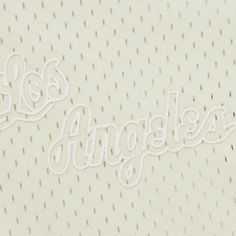 the los angeles lakers logo is shown in white on a beige jersey with polka dots