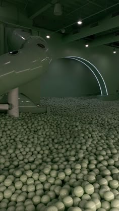 a large room filled with lots of green balls