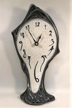 an ornate clock with roman numerals and numbers on the face is displayed against a white background