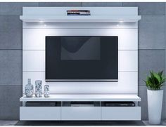 a white entertainment center with a flat screen tv mounted on it's side wall