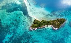 an island in the middle of some blue water