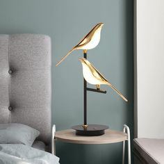 a lamp that is sitting on top of a table next to a bed in a room