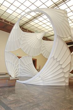 a large white sculpture sitting inside of a building