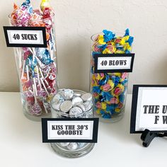 candy jars filled with candies and lollipops on top of a table