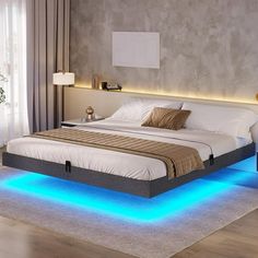 a large bed with blue lights on the sides and headboard is in a bedroom