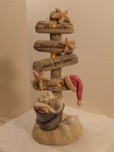 a christmas tree made out of driftwood with starfish and seashells on it