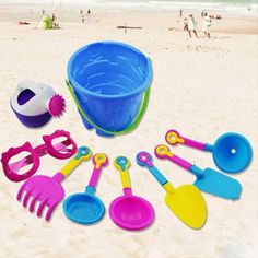 toys on the beach with people in the water and sunbathers behind them,