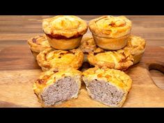 some meat pies are on a cutting board