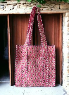 a pink and white bag sitting on top of a fireplace