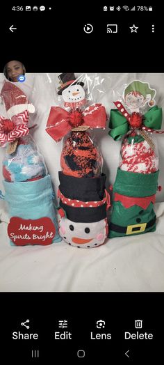 three snowmen are wrapped in plastic and sitting next to each other