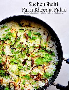 a pan filled with rice and vegetables on top of a table