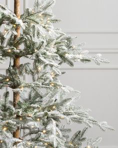 a small white christmas tree with lights on it