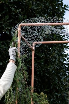 a person is holding up a piece of wire