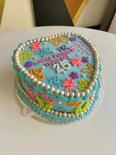 a decorated birthday cake sitting on top of a table