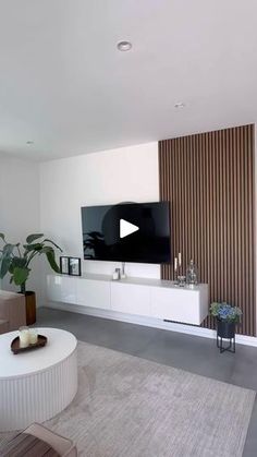 a living room filled with furniture and a flat screen tv on top of a wall