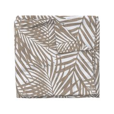 a brown and white palm leaf print pocket square on top of a bed sheet with two matching pillow cases