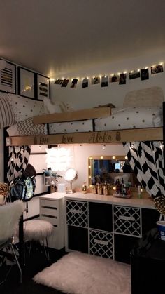 a bedroom with bunk beds, desk and lights on the ceiling above it is decorated in black and white