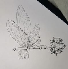 a drawing of a dragonfly on top of a key