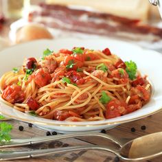 a plate of spaghetti with meat and tomato sauce