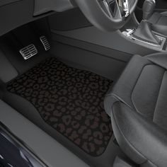 the interior of a car with an animal print floor mat