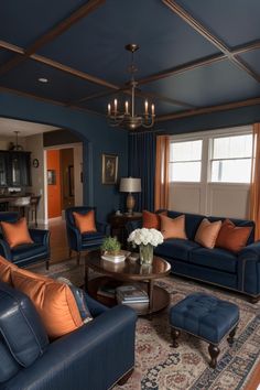 a living room with blue couches and orange pillows