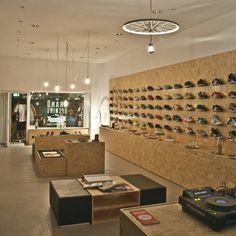 there are many pairs of shoes on the wall in this store, and one is for sale