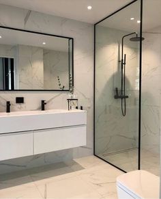 a modern bathroom with marble walls and floor